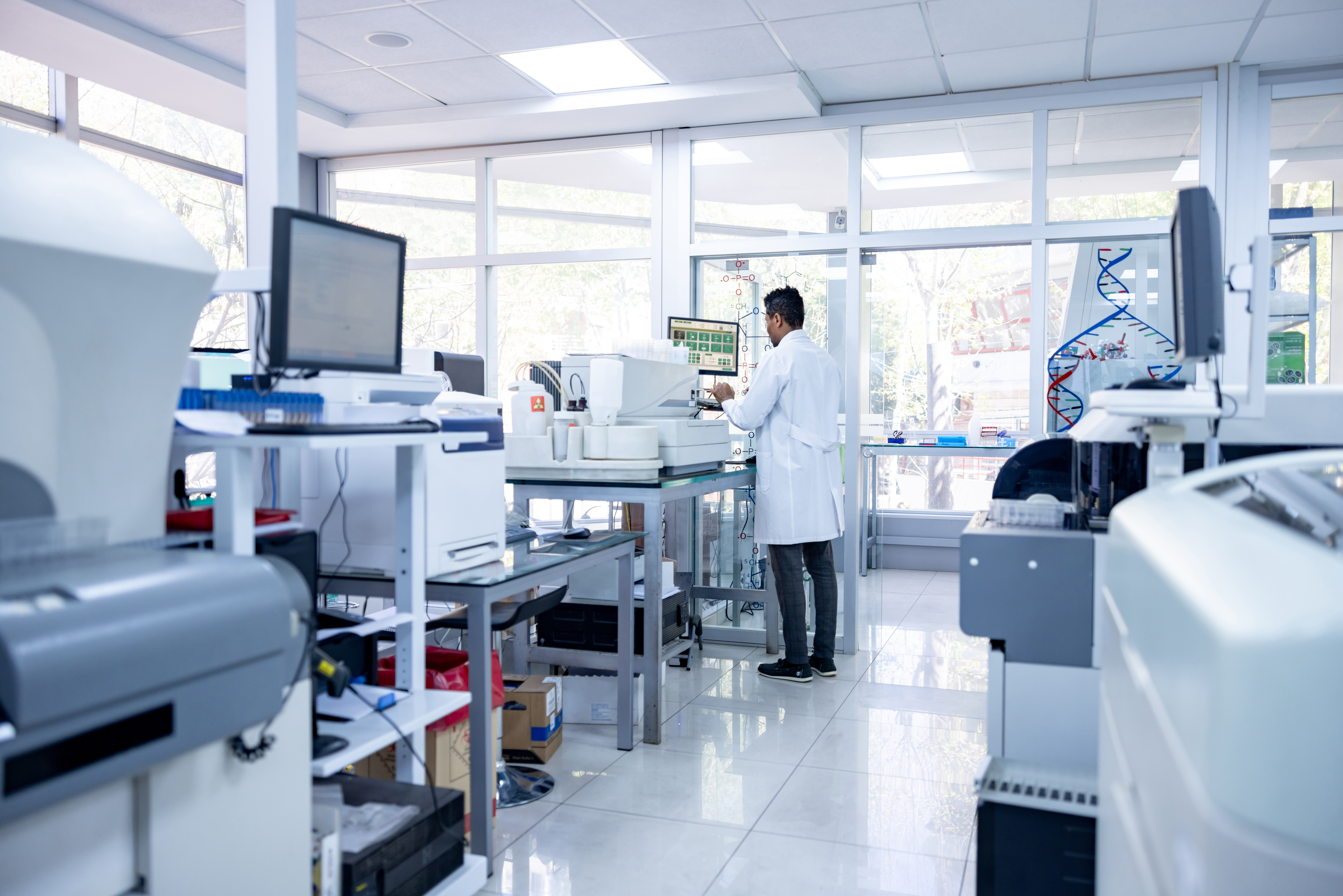 African American scientist working doing some research at a laboratory and using a computer - healthcare and medicine concepts
